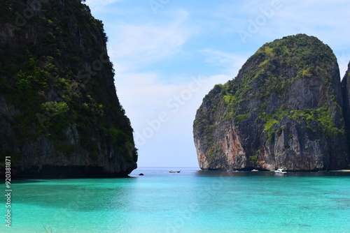 KOH PHI PHI, THAILAND - MARCH 11 2022: Motor boats on turquoise water of Maya Bay lagoon on MARCH 11, 2022 in Koh Phi Phi island, Thailand. This was extremely quiet due to the Covid 19 pandemic.