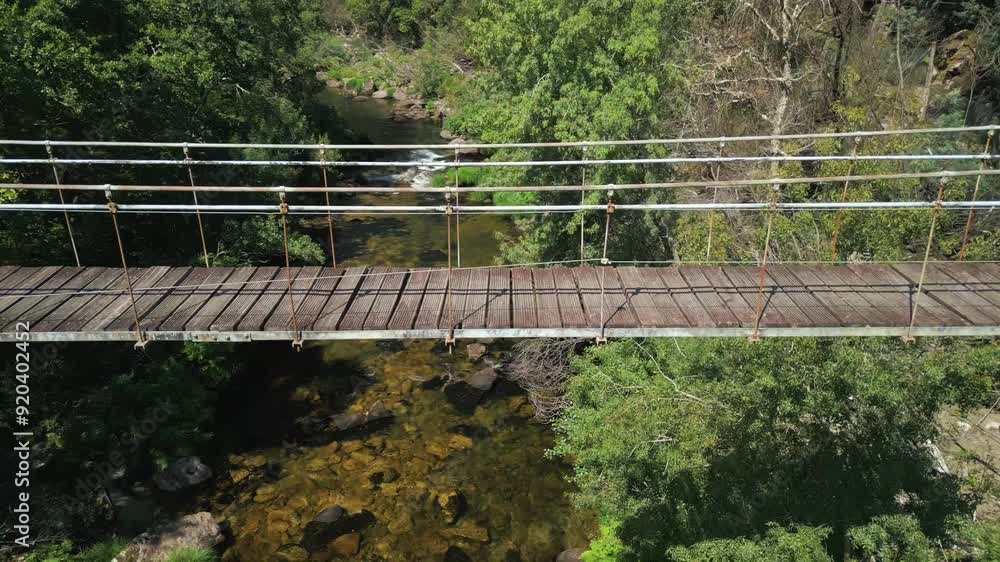 Wooden Bridge Of Ponte Colgante de Calvelo In Rio Lerez, Pontevedra, Spain. Aerial Panning Up Shot Wooden Bridge Of Ponte Colgante de Calvelo In Rio Lerez, Pontevedra, Spain. Aerial Panning Up Shot