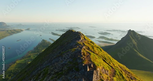 Flight over trails along arctic Prestkona mountain ridge in sunset glow; Steigen photo