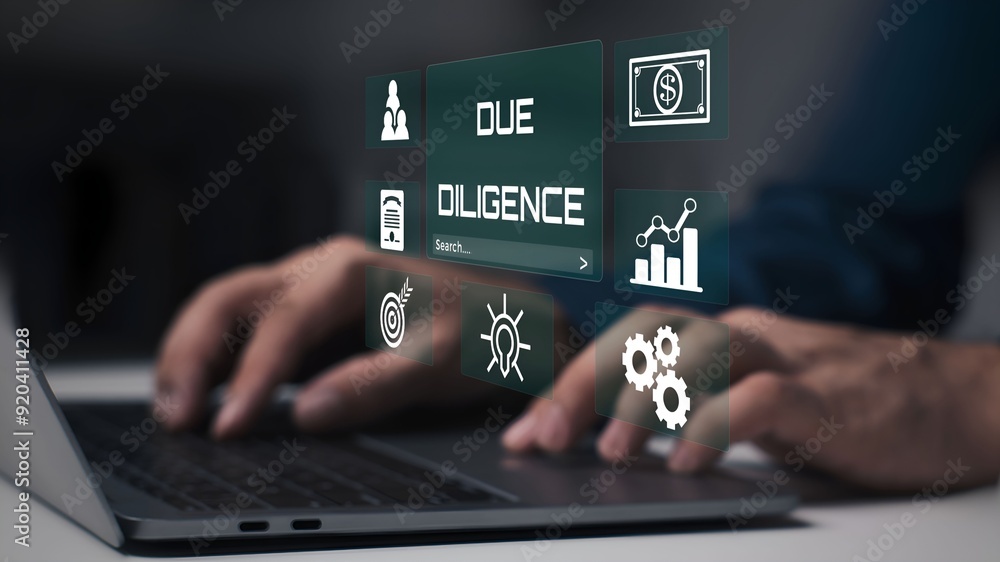 A businessman using laptop with Due diligence visual concept. A businessman using laptop with Due diligence visual concept.