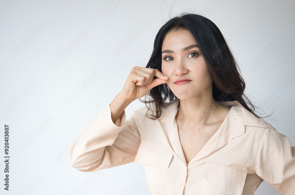 Asian woman asking for your cooperation to keep silent, make no noise with angry and furious expression, zip it or shut up gesture Asian woman asking for your cooperation to keep silent, make no noise with angry and furious expression, zip it or shut up gesture
