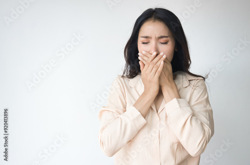 Fearful and speehless Asian woman covers her mouth, South Asian woman can not speak freely due to censorship, no free speech, no freedom of speech concept photo