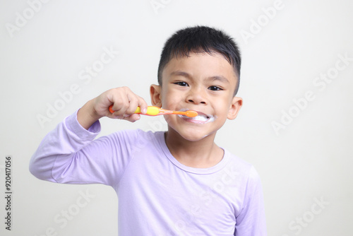 child Asia kid boy brushing teeth isolated on white backgroud.