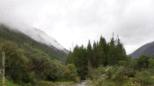 Stunning mountain covered by clouds and trees all around, national park