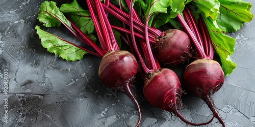 A selection of new red beets on a wooden backdrop. photo