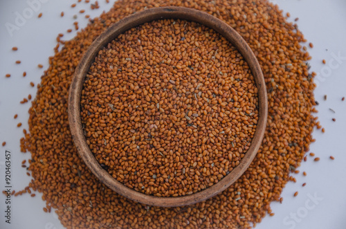 Canvastavla Camelina sativa seeds, camelina seeds in wooden bowl isolated on white background