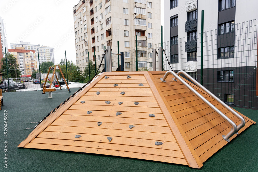 A contemporary wooden climbing structure designed for use in an urban playground setting, enhancing leisure activities A contemporary wooden climbing structure designed for use in an urban playground setting, enhancing leisure activities