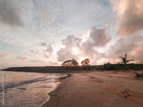 Low angle view of beautiful sunrise by the beach in Besut, Terengganu, Malaysia. photo