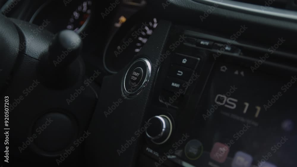 Close up Hand turning on the car engine button Close up Hand turning on the car engine button