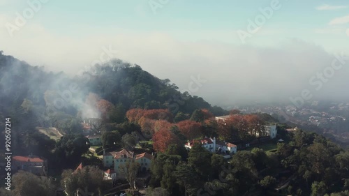 Aerial track and tilt shot of a cloudy mountain town outside of Sintra, Portgual near Lisbon