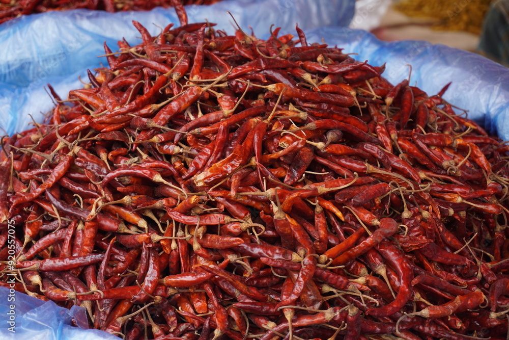 Fototapeta premium A heap of dry red chili pepper is displayed in a spice market, Dried spicy red chilies are on sale, Showcase of spicy red chili in a spice shop in Asia for the spice trade
