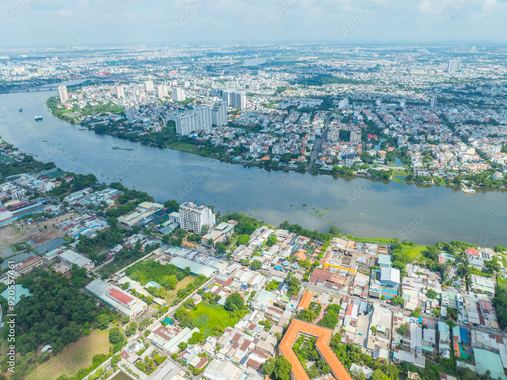 Obraz premium Panoramic view of Saigon, Vietnam from above at Ho Chi Minh City's central business district. Cityscape and many buildings, local houses, bridges, rivers.