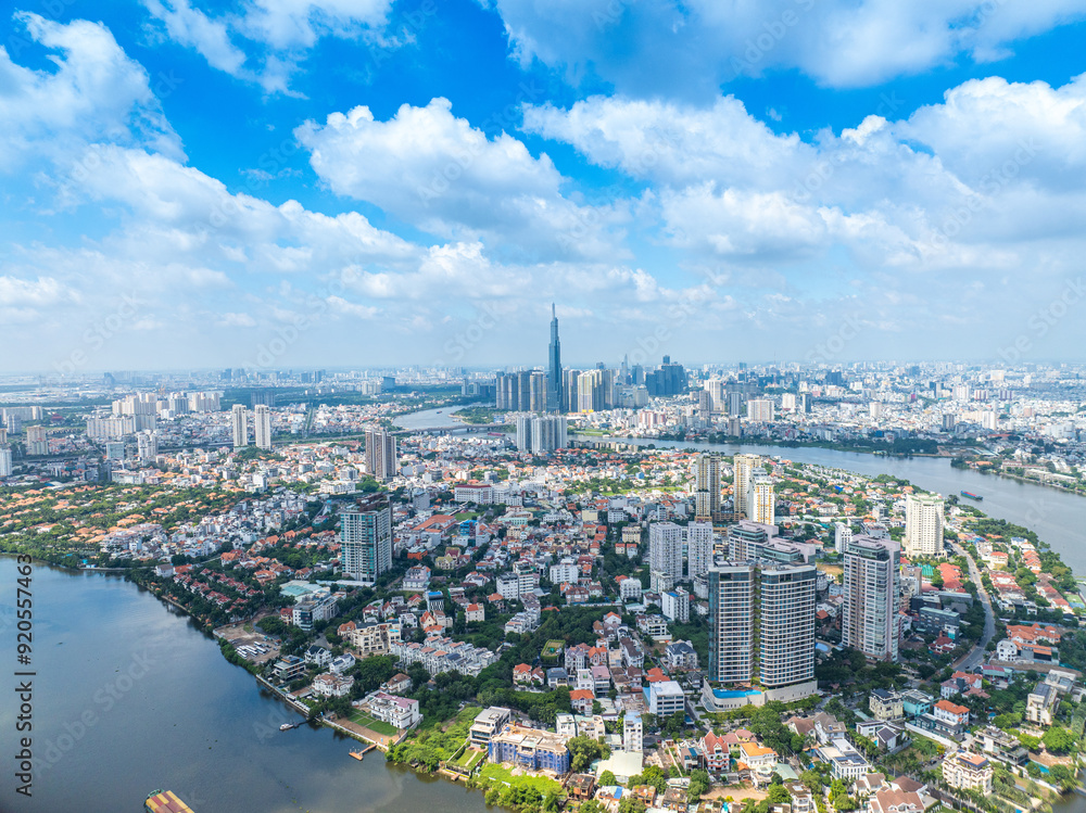 Fototapeta premium Panoramic view of Saigon, Vietnam from above at Ho Chi Minh City's central business district. Cityscape with Landmark 81 skyscraper and many buildings, local houses, rivers.