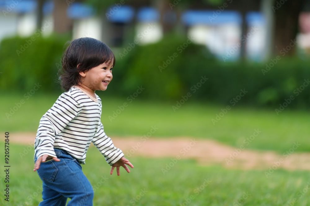 happy toddler baby girl running on grass field in park happy toddler baby girl running on grass field in park