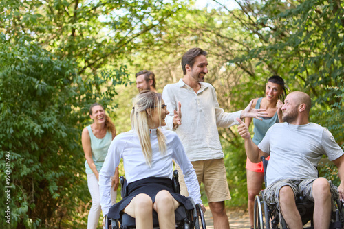 Group of friends, including people using wheelchairs, enjoying a sunny day outdoors together