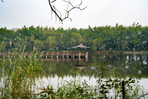 Traditional Chinese pavilion building in the middle of the park lake photo