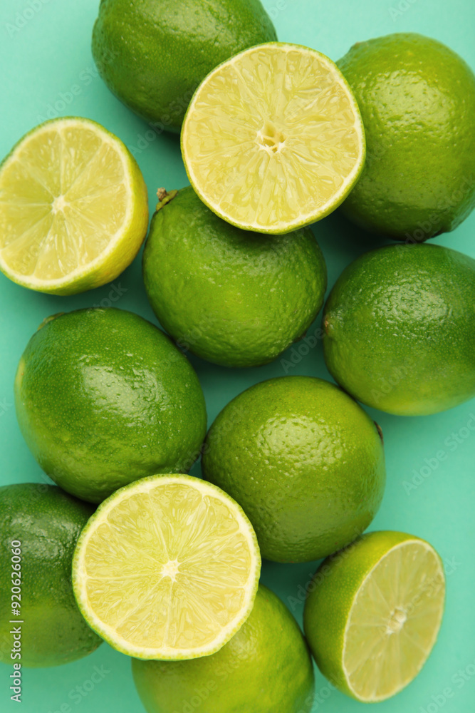 Green lime with cut in half on mint background. Vertical photo Green lime with cut in half on mint background. Vertical photo