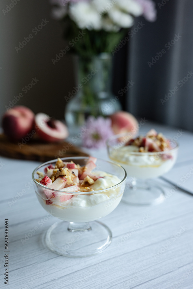 Greek yoghurt with peach and honey. Hight key. Place for text Greek yoghurt with peach and honey. Hight key. Place for text