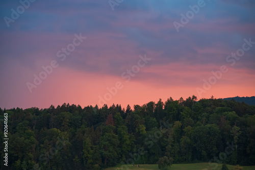 Dramatic sunset clouds over a mountain pine forest in Europe, no people