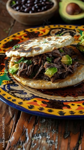 Close upd esde arriba de Arepa rellena de carne en hebras (carne mechada) rodeada de arepas sin relleno contenidas en una cesta. AI generated illustration photo