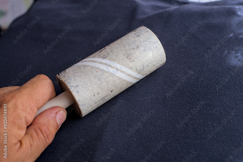 Insulated clothes cleaning roller in human hand