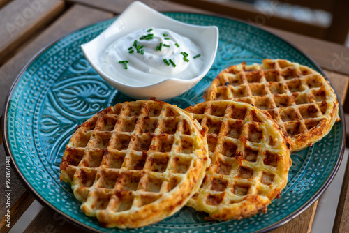 zucchini waffles gofri with sour cream dip on a plate