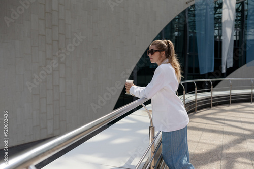 blonde woman in a suit doing business walking down the street