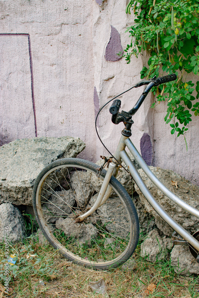 old bicycle leaning against a wall old bicycle leaning against a wall