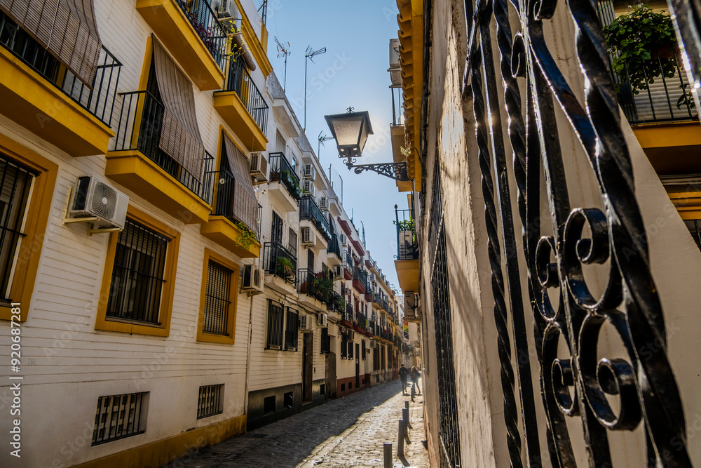 Charming street with lantern in historic old town of Seville, Spain