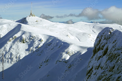 Snowy landscape from Biogradska Gora National Park: view from the side of Zekova Glava peak with a tower built on it. Winter in northern Montenegro - mountains around Kolasin. photo