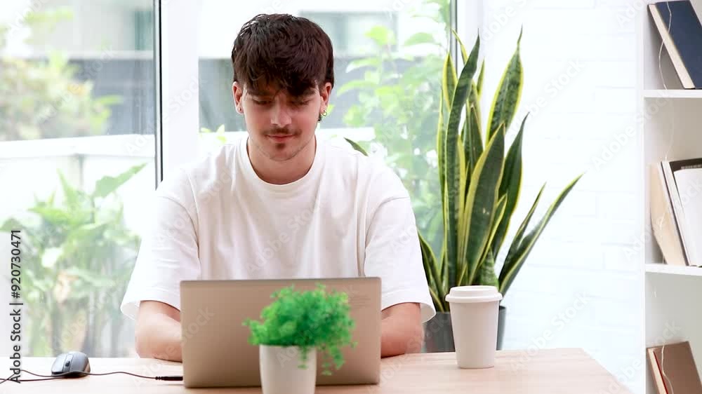 young man with laptop at desk celebrating euphoric young man with laptop at desk celebrating euphoric