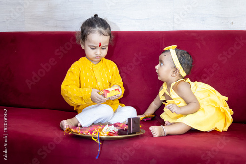 brother and sister cute expression on the occasion of hindu raksha bandhan festival at indoor photo