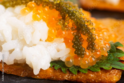 Inari sushi with caviar, rice, shiso and umibudo photo