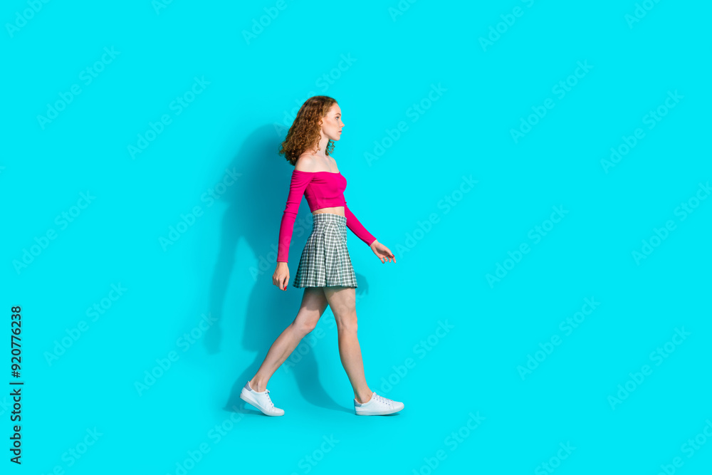 Full body profile portrait of lovely young girl walk empty space wear top isolated on turquoise color background Full body profile portrait of lovely young girl walk empty space wear top isolated on turquoise color background