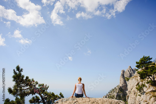 Photography person sitting on a rock