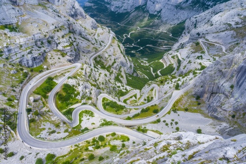 Winding road - Lovcensky serpentine with dangerous turns that leads to the top of the Montenegrin mountains covered with vegetation. Beautiful simple AI generated image in 4K, unique. photo