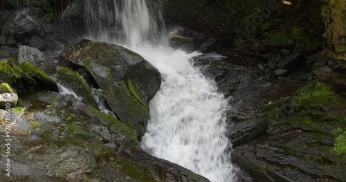 Mid shot of the waterfall landing onto rocks and flowing away at Lumsdale waterfalls, Matlock photo