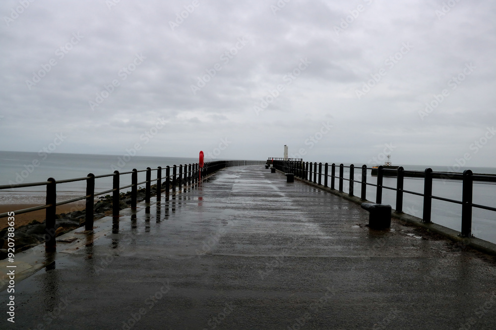 Coastal Jetty at a Harbour Entrance on a Rainy Overcast Summer Morning Coastal Jetty at a Harbour Entrance on a Rainy Overcast Summer Morning