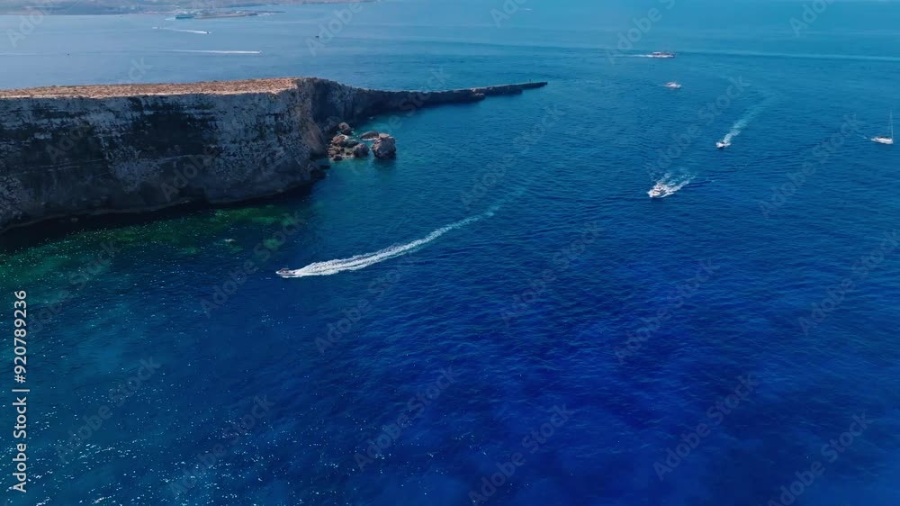 Aerial video capturing boats cruising along Malta's rugged coastline, showcasing the island's dramatic cliffs and deep blue Mediterranean waters. Perfect for travel and nature enthusiasts (4K) Aerial video capturing boats cruising along Malta's rugged coastline, showcasing the island's dramatic cliffs and deep blue Mediterranean waters. Perfect for travel and nature enthusiasts (4K)