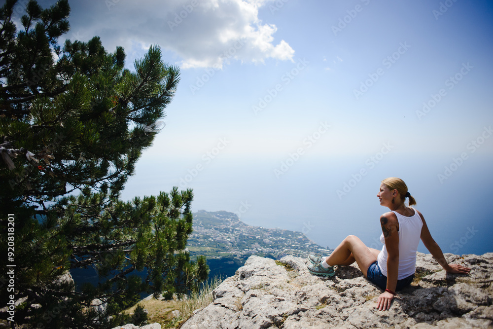woman sitting on rock woman sitting on rock