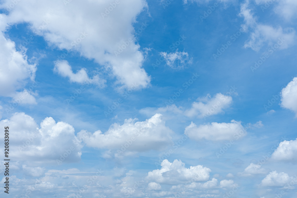 A serene blue sky dotted with white clouds A serene blue sky dotted with white clouds