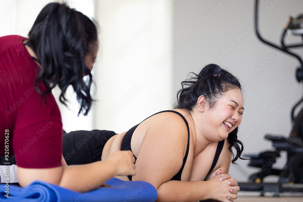 Tired fat asian woman lies on floor gym. beautiful young chubby overweight woman wearing sporty fitness clothes doing exercise indoors at gym fitness sport club, body and health care Tired fat asian woman lies on floor gym. beautiful young chubby overweight woman wearing sporty fitness clothes doing exercise indoors at gym fitness sport club, body and health care
