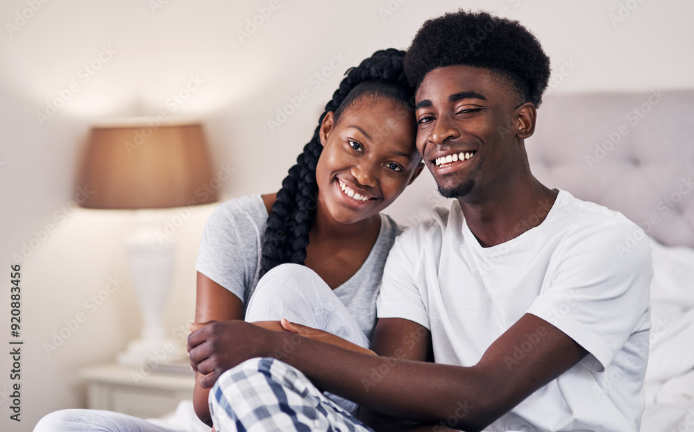Portrait, black couple and relax with smile in bedroom for love, care and embrace of romance bonding in morning. Happy, man and woman with marriage commitment, trust and relationship support at house Portrait, black couple and relax with smile in bedroom for love, care and embrace of romance bonding in morning. Happy, man and woman with marriage commitment, trust and relationship support at house