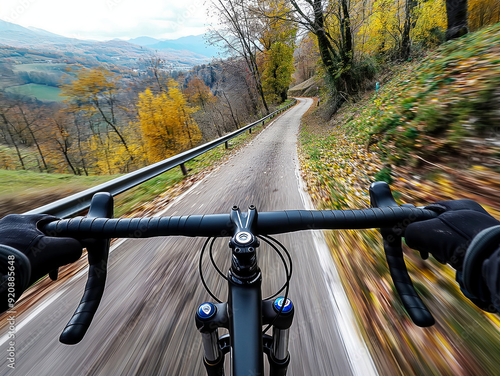 A person is riding a bike down a road with a beautiful view of the mountains in the background A person is riding a bike down a road with a beautiful view of the mountains in the background