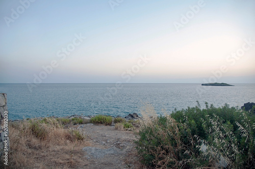 View of the horizon with an islet at twilight. Marina di Camerota, Salerno, Italy. photo