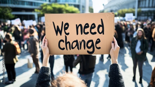 A person holding a sign with the text 