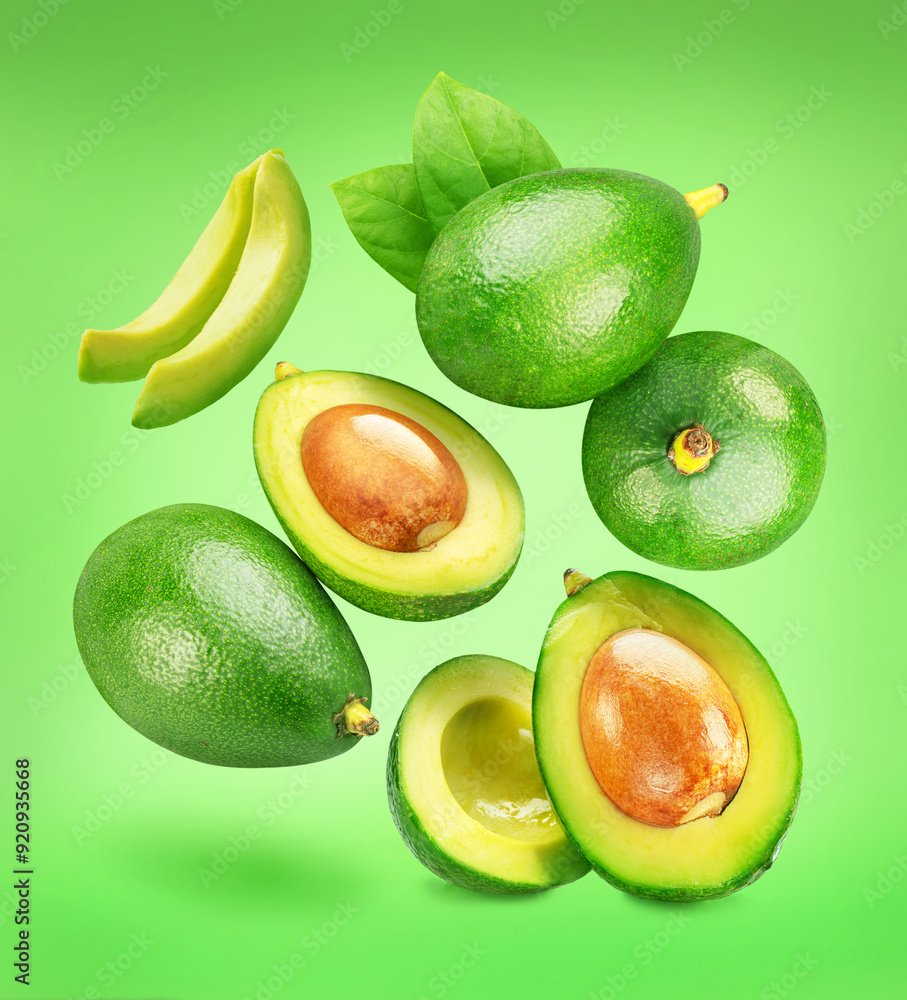 Lot of avocado fruits and avocado slices levitating in air on green background. Clipping paths. Lot of avocado fruits and avocado slices levitating in air on green background. Clipping paths.