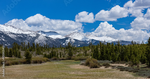 colorado snow capped mountains with a prairie in the foreground