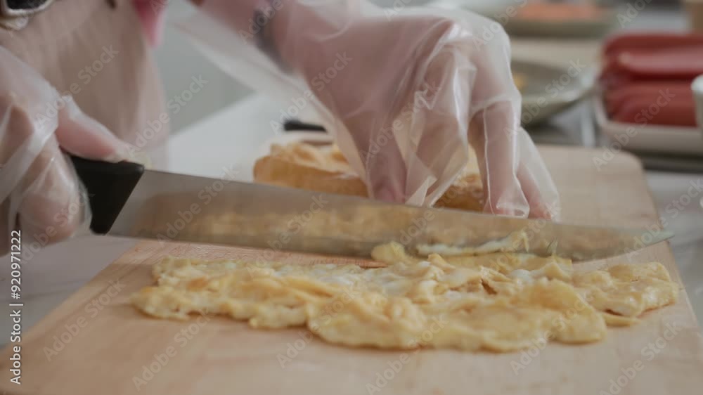 Close up of hands of anonymous woman cutting omelet at home kitchen Close up of hands of anonymous woman cutting omelet at home kitchen