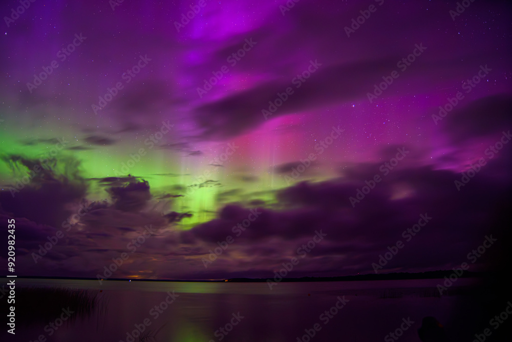 red green aurora borealis in lake with clouds red green aurora borealis in lake with clouds